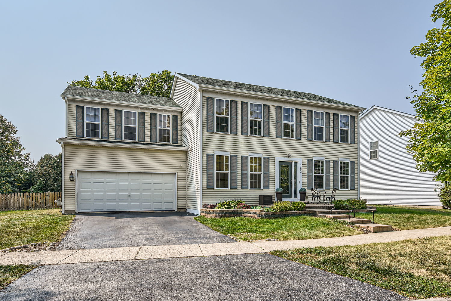 a front view of a house with a yard and a garage