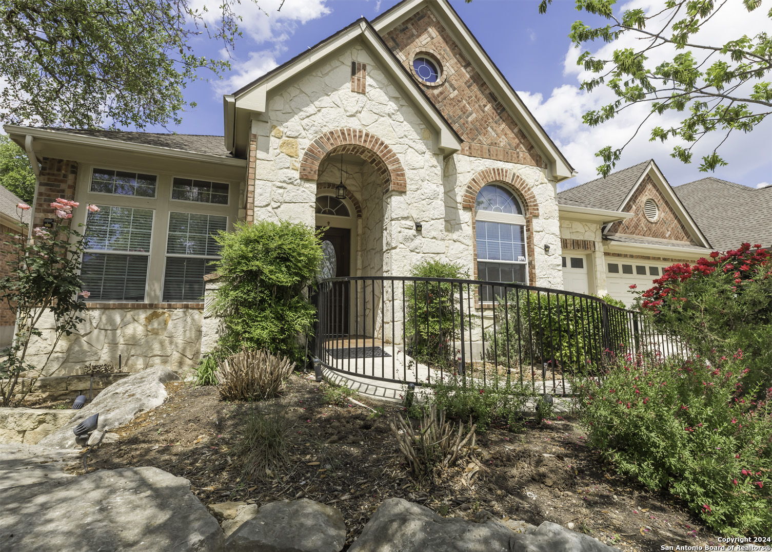 a front view of a house with a garden