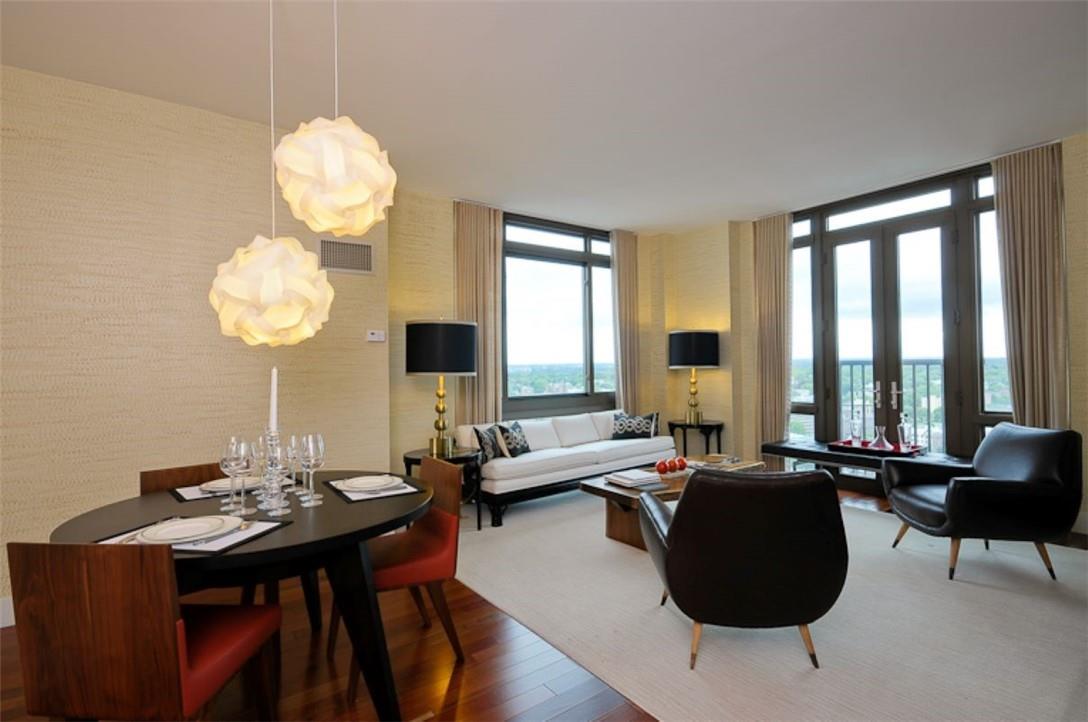 Virtually staged photo of dining area/living room with Juliette doors over looking Lower Westchester and partial NYC skyline.