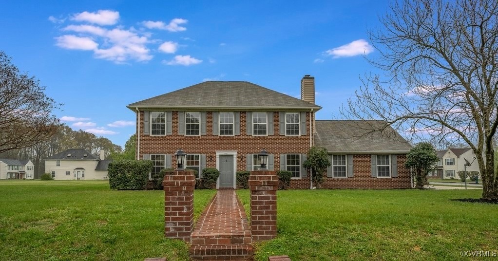 Colonial home with a front lawn