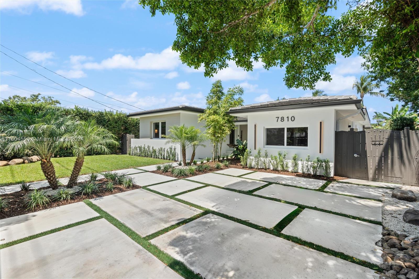 a view of a house with backyard sitting area and garden