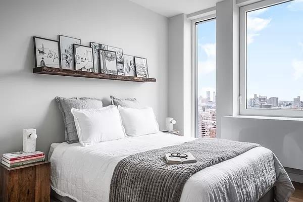 a bedroom with a bed a mirror and wall painting