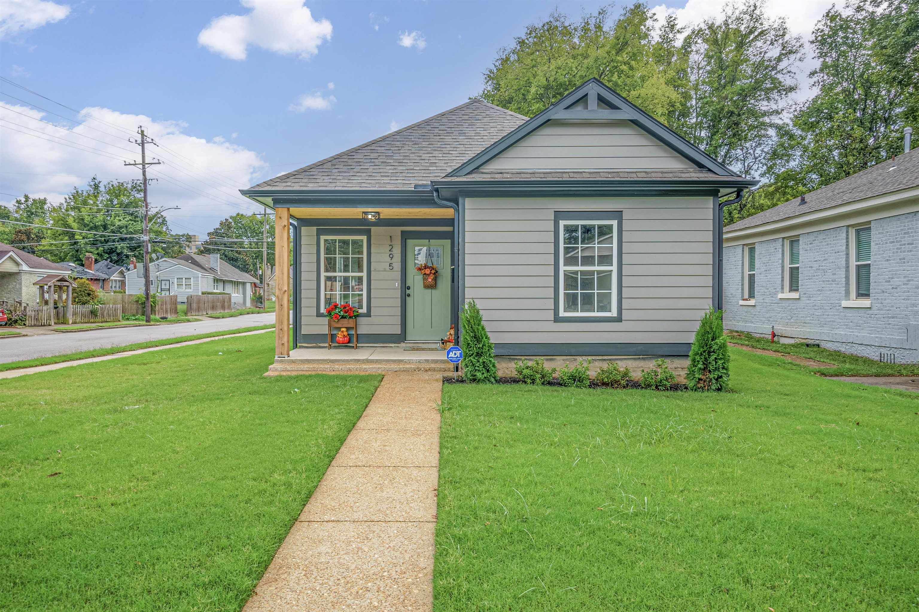 a front view of a house with a yard and porch