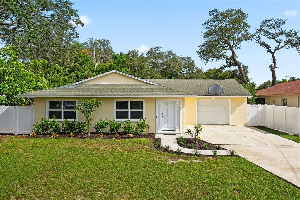 a front view of house with yard and green space