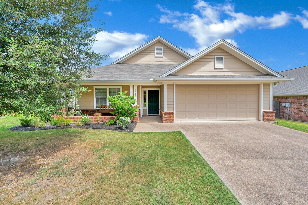 a front view of house with yard and green space