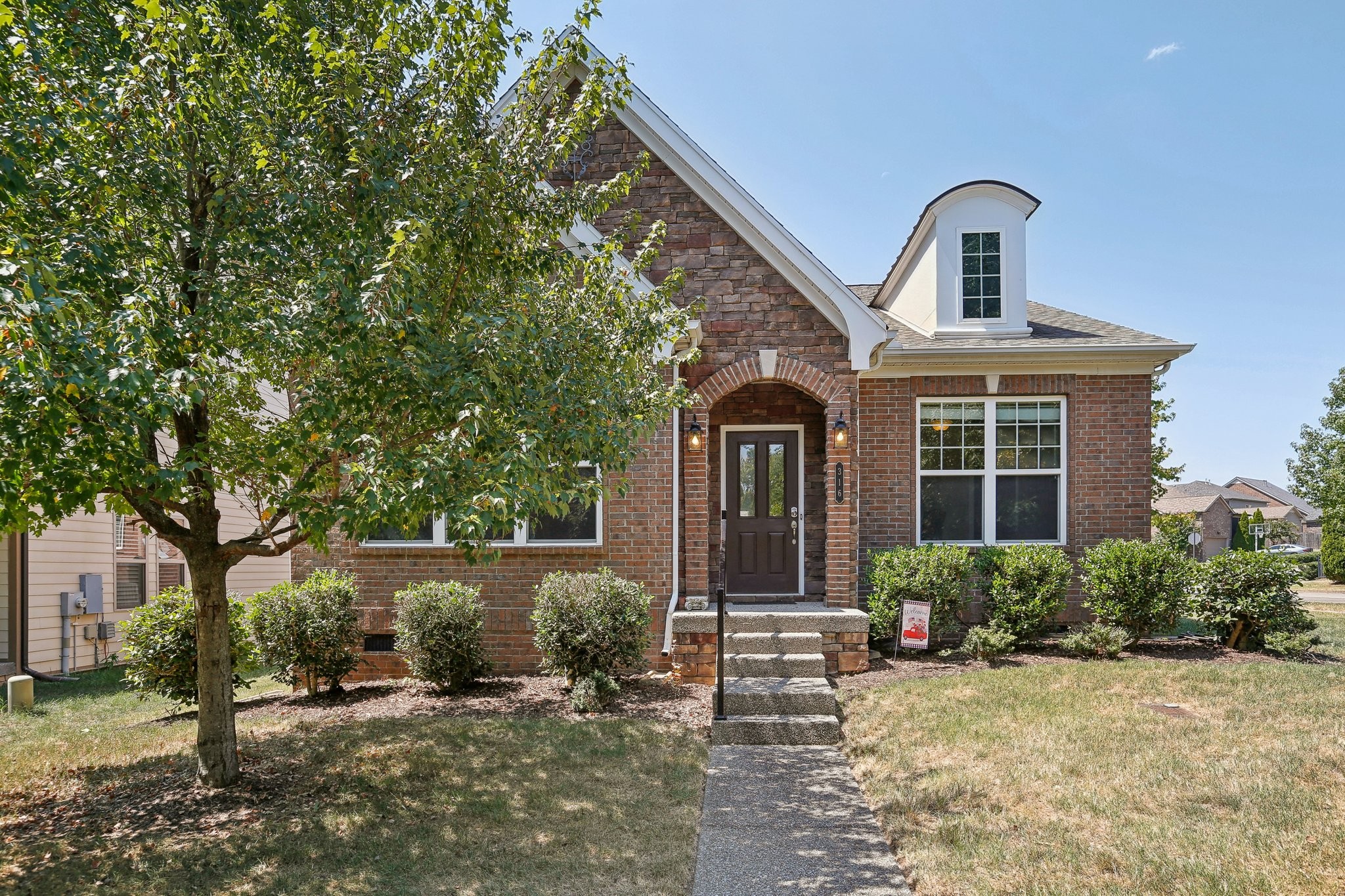 a front view of a house with garden