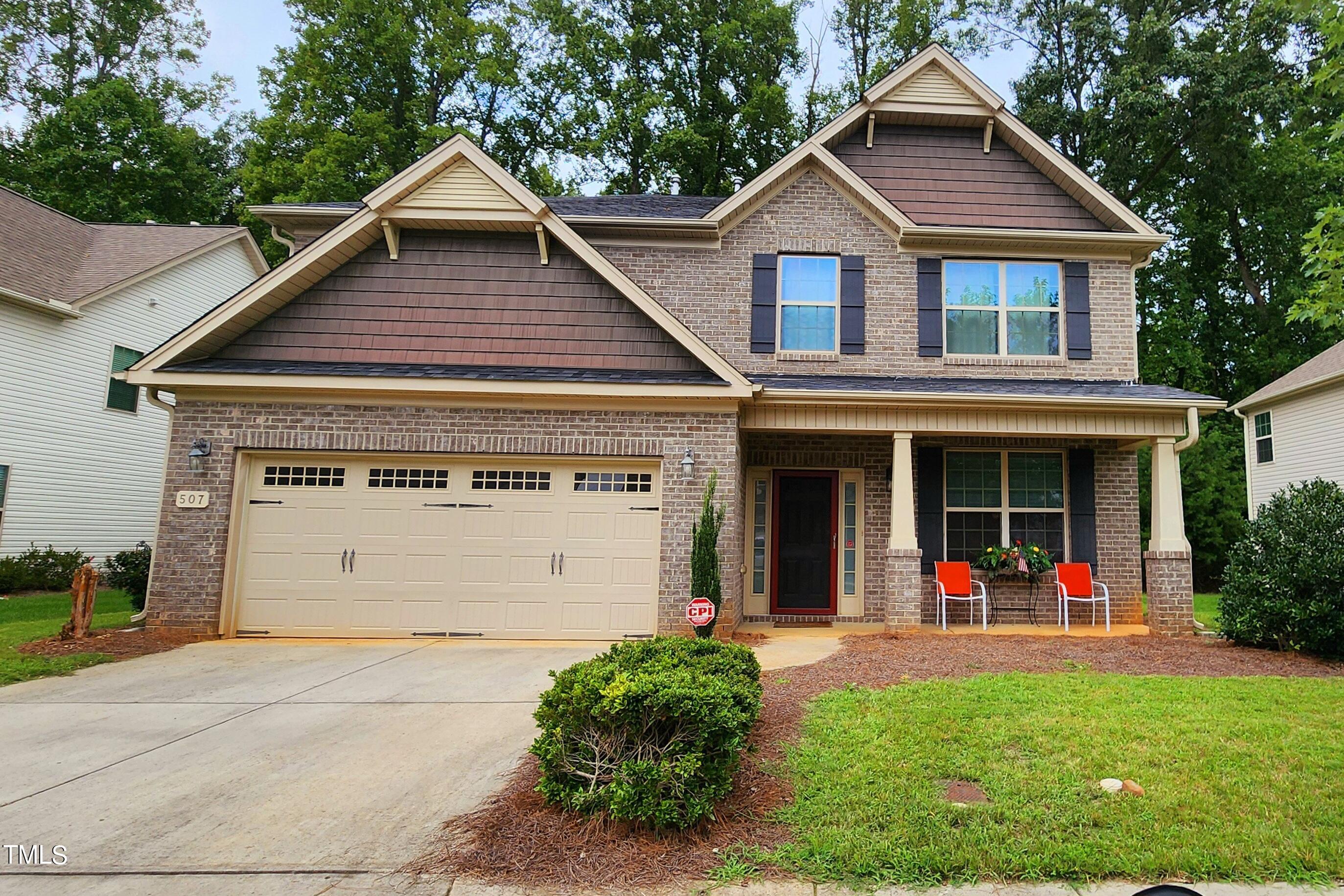 a view of a house with a yard and plants