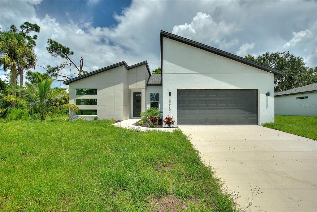 a front view of house with yard and green space