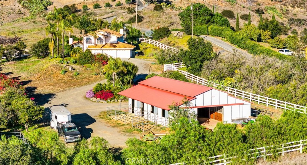 an aerial view of a house with yard and outdoor seating