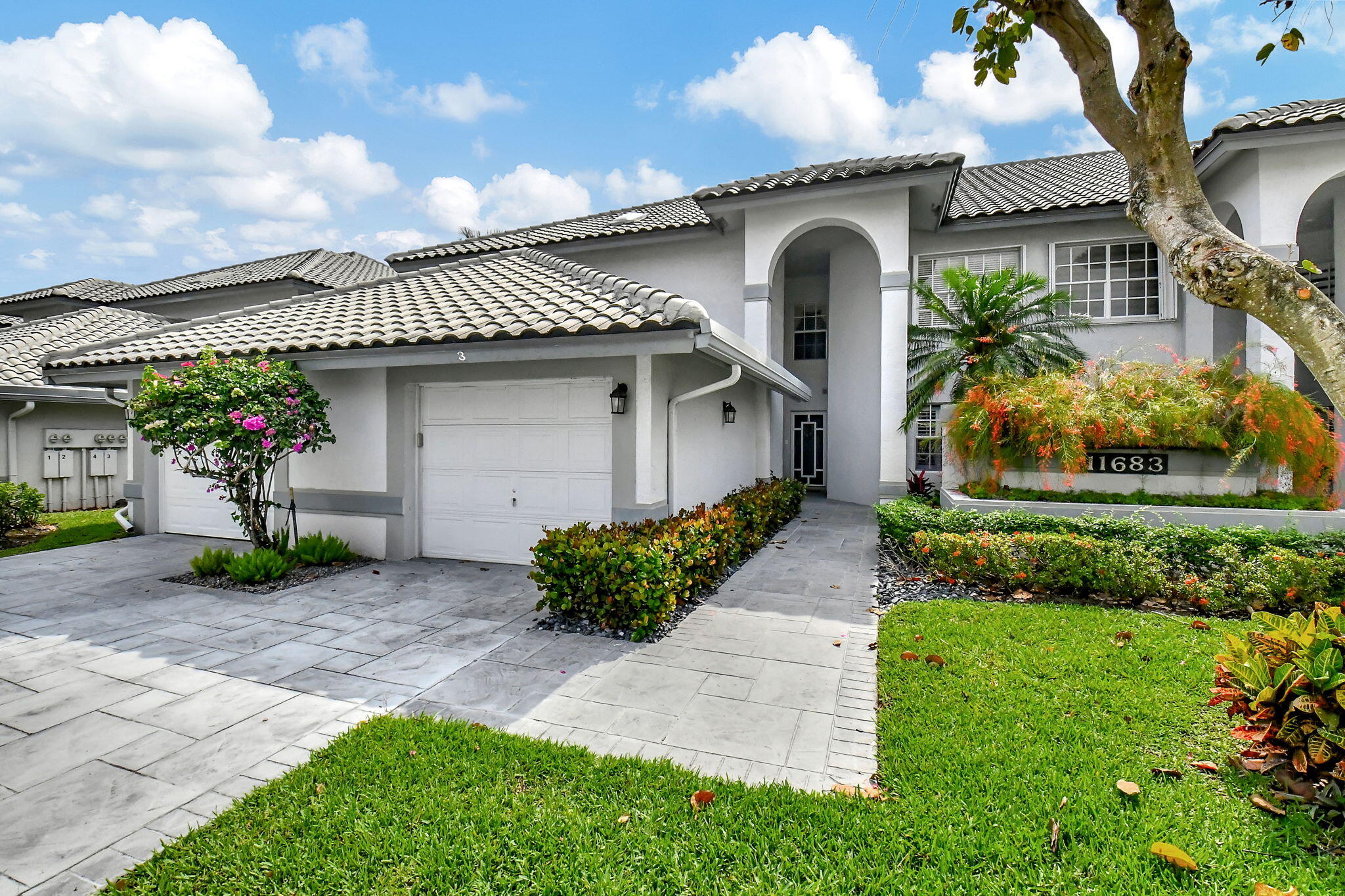 a front view of a house with garden