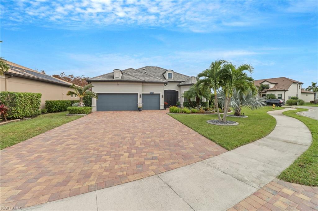 View of front of property with a front lawn and a garage