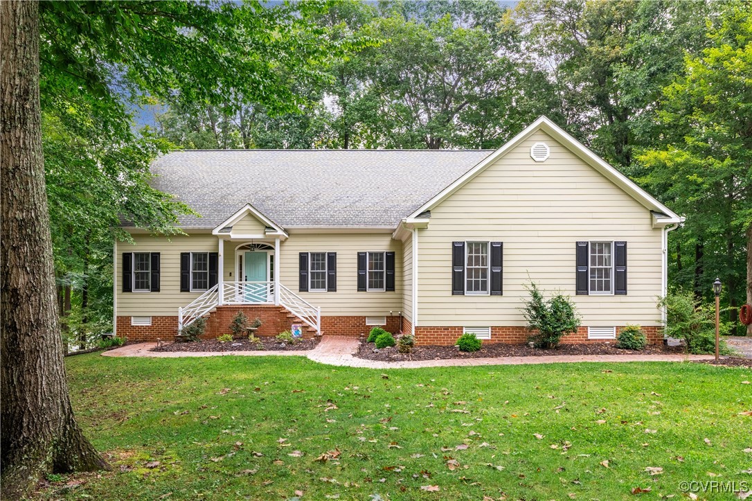 a front view of house with yard and green space