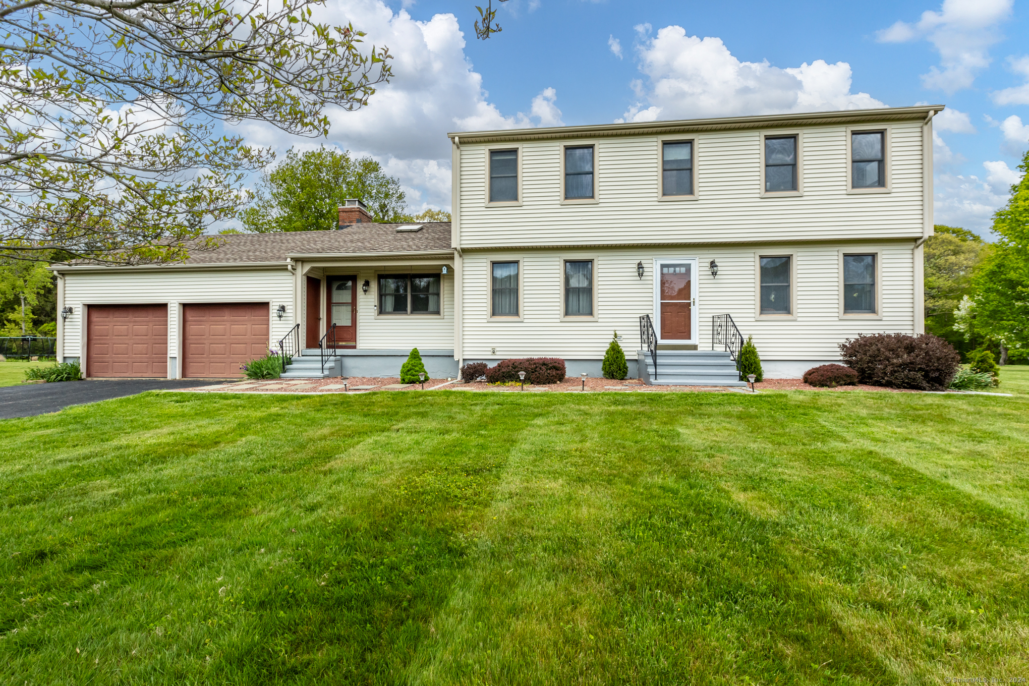 a front view of house with yard and green space