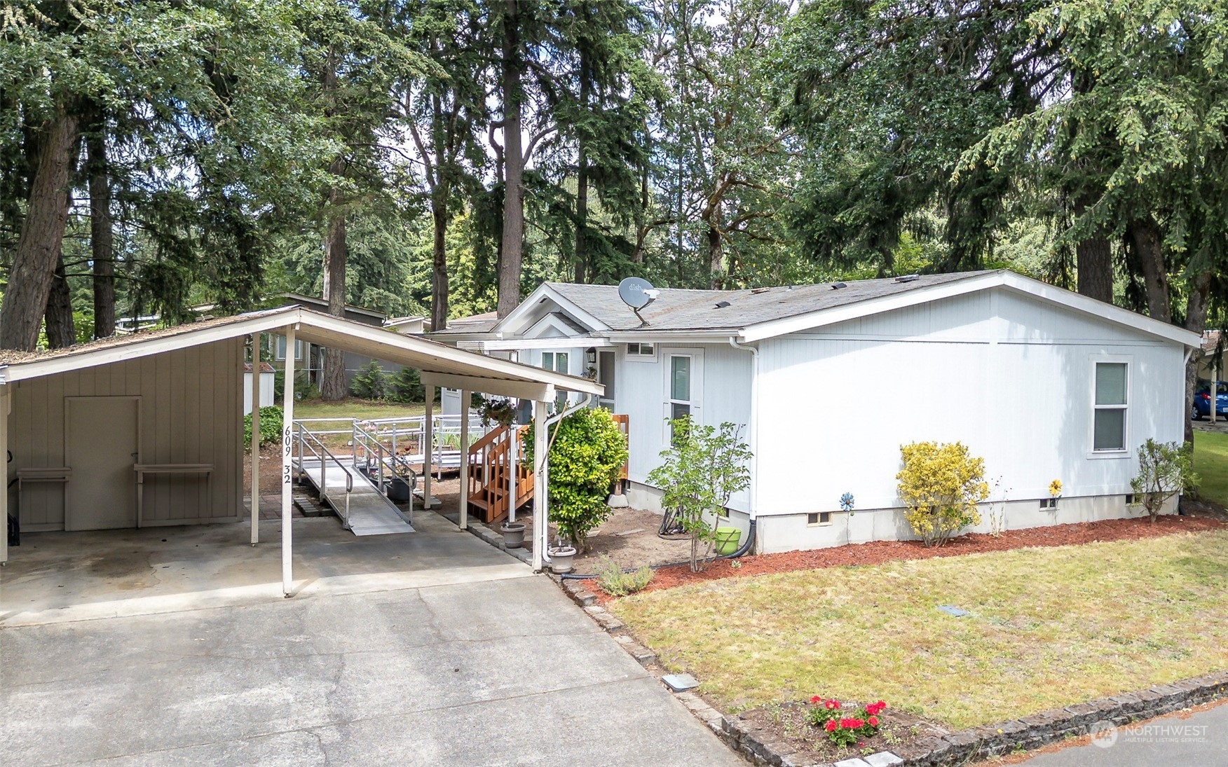 a view of a patio with table and chairs under an umbrella