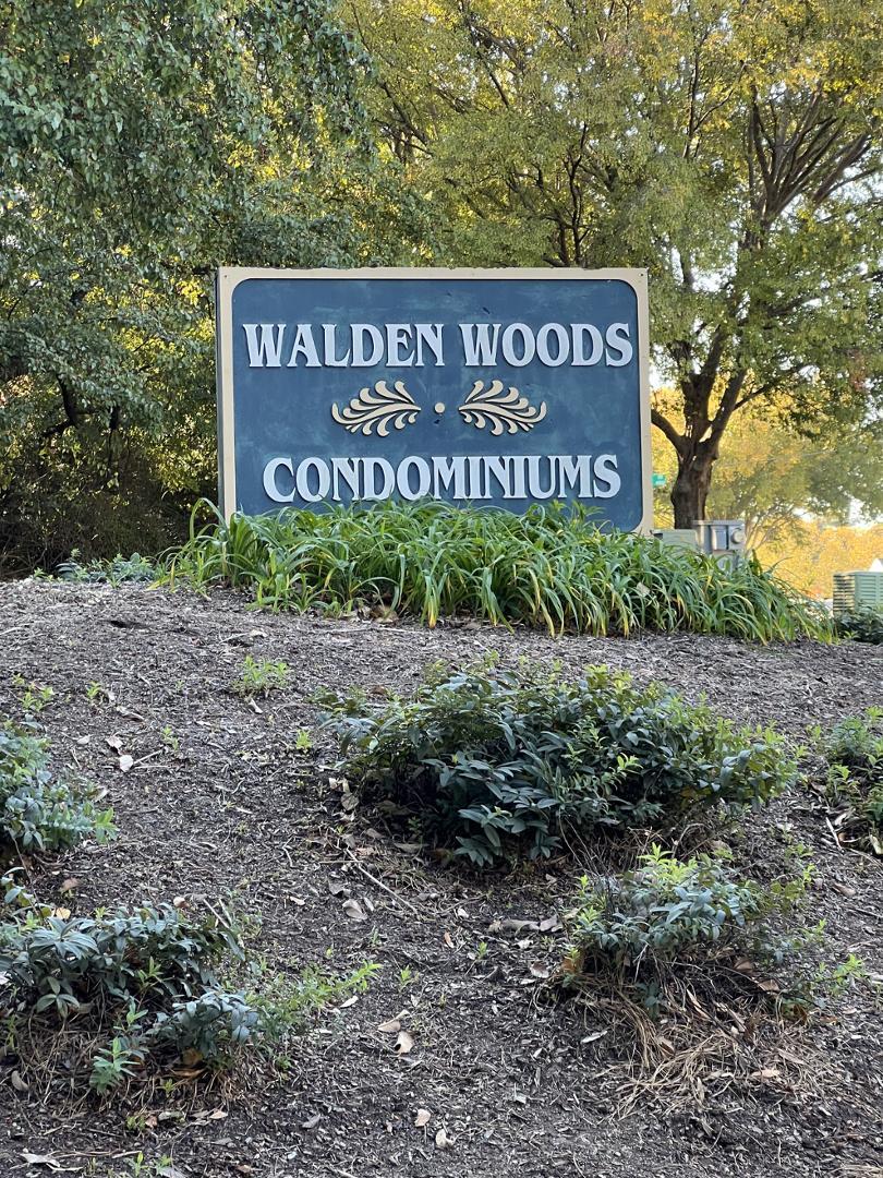 a sign broad in front of red brick house