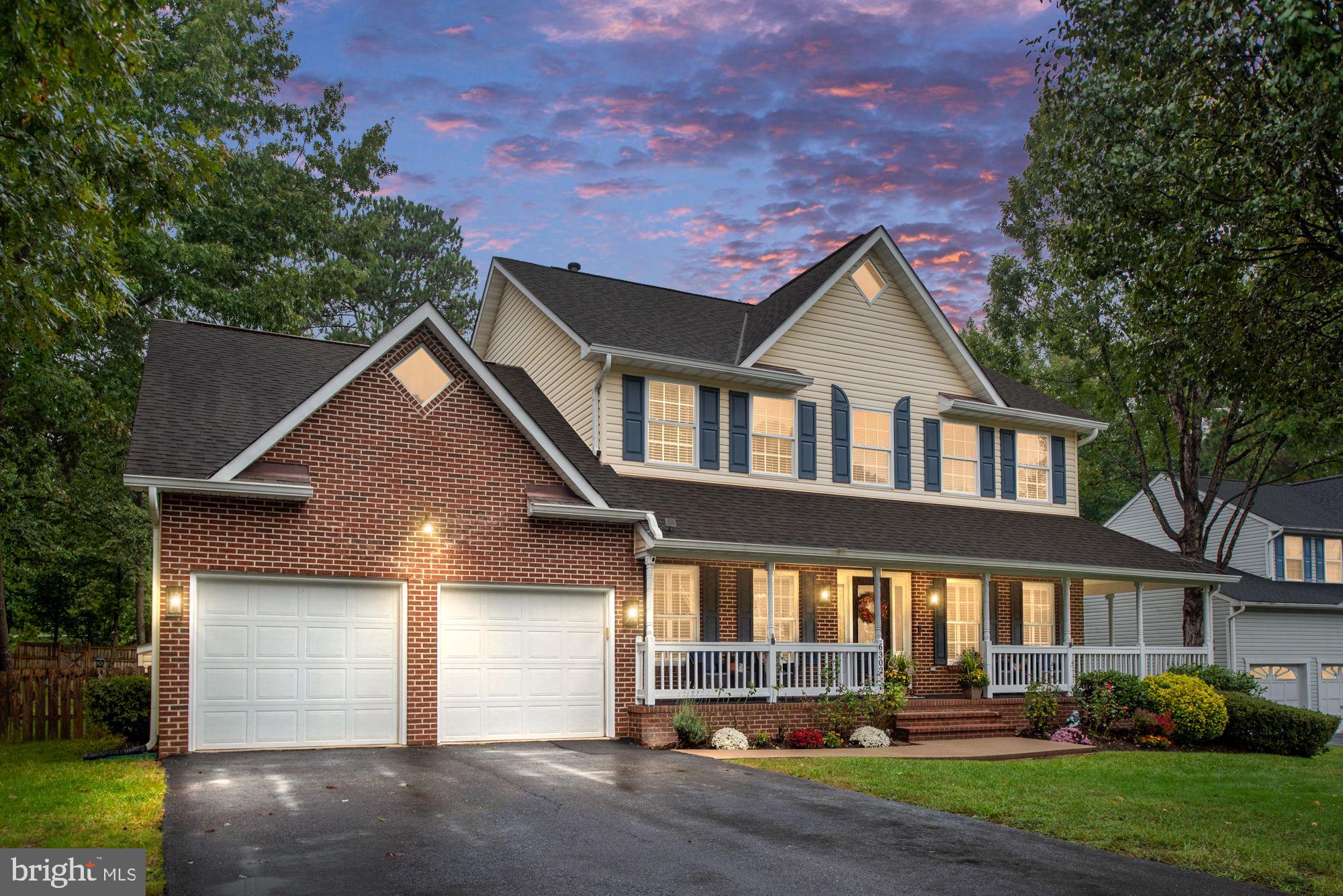 a front view of a house with a yard and outdoor seating