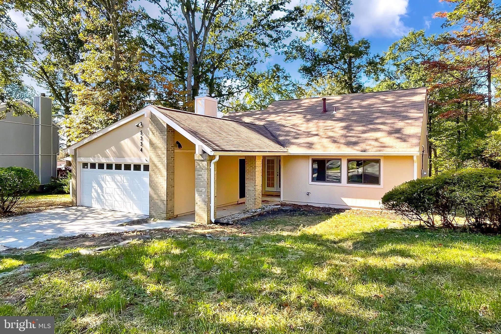 a view of a house with a yard and fence