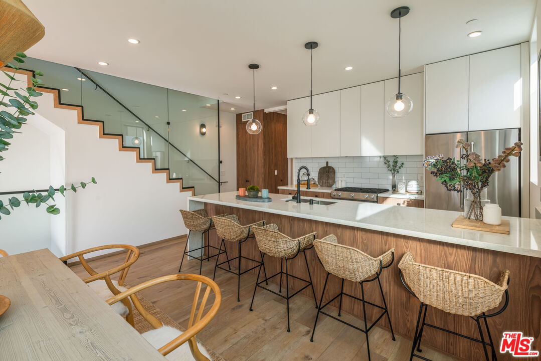 a kitchen with a table chairs stove and cabinets