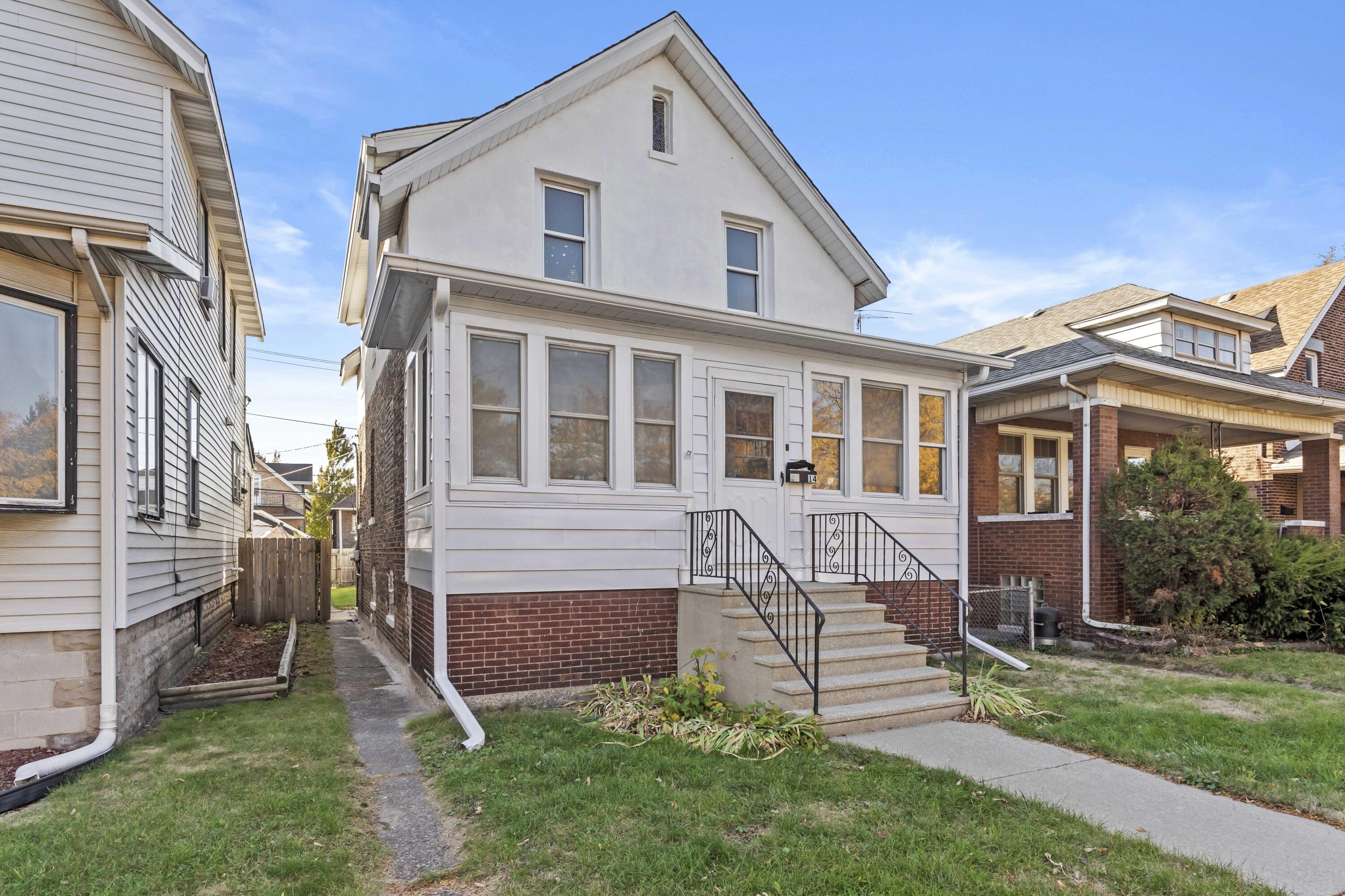 a front view of a house with a yard table and chairs