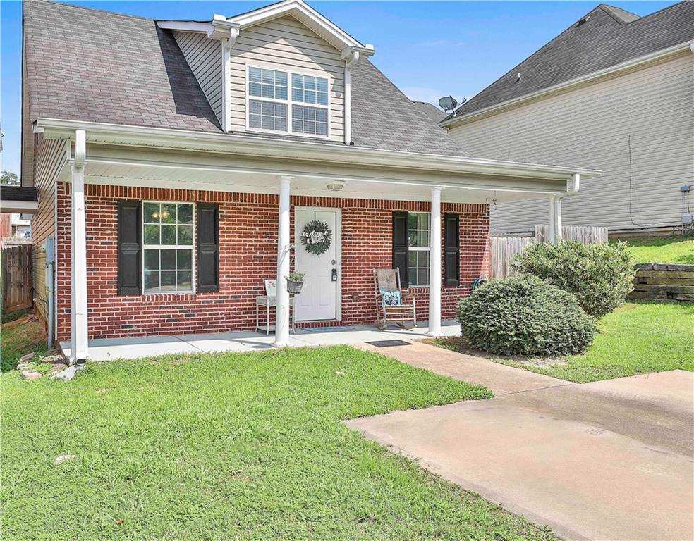 front view of a brick house with a yard