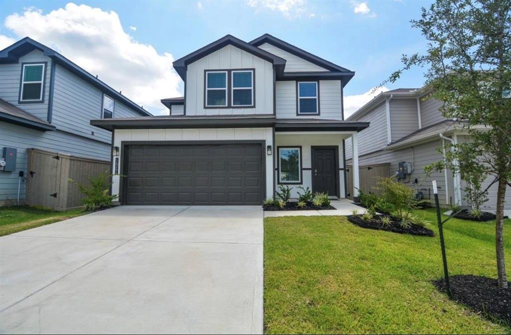 a front view of a house with a yard and garage