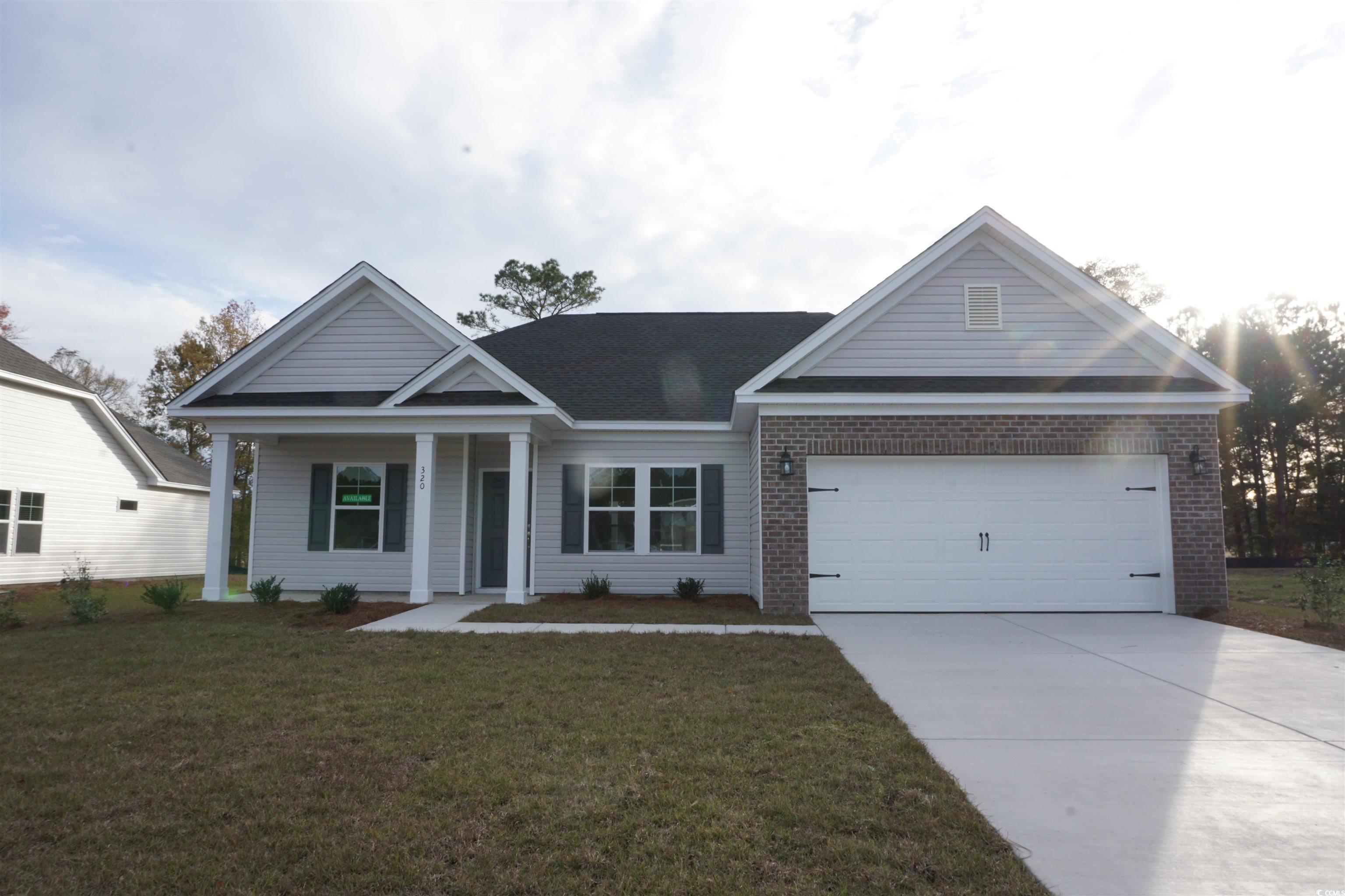 View of front of property with a porch, a garage,