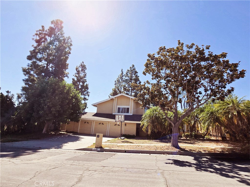 a front view of a house with a yard and trees