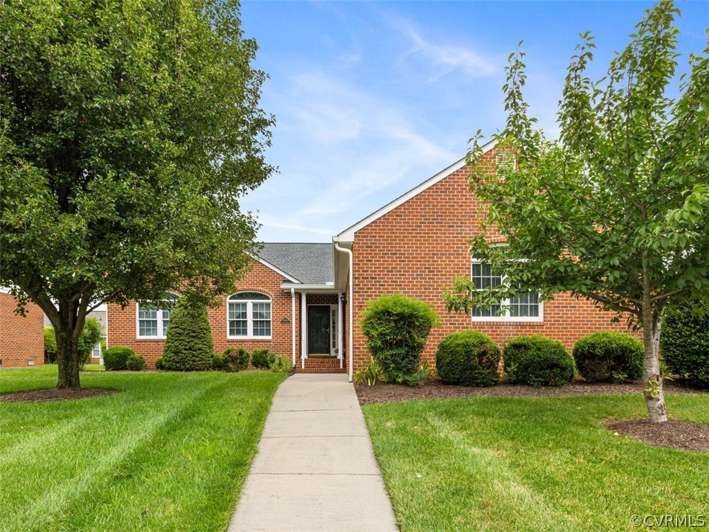 a front view of a house with yard and green space