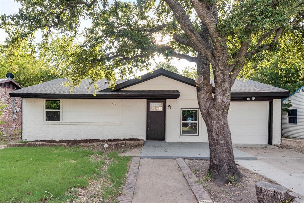 a house that has a tree in front of the house