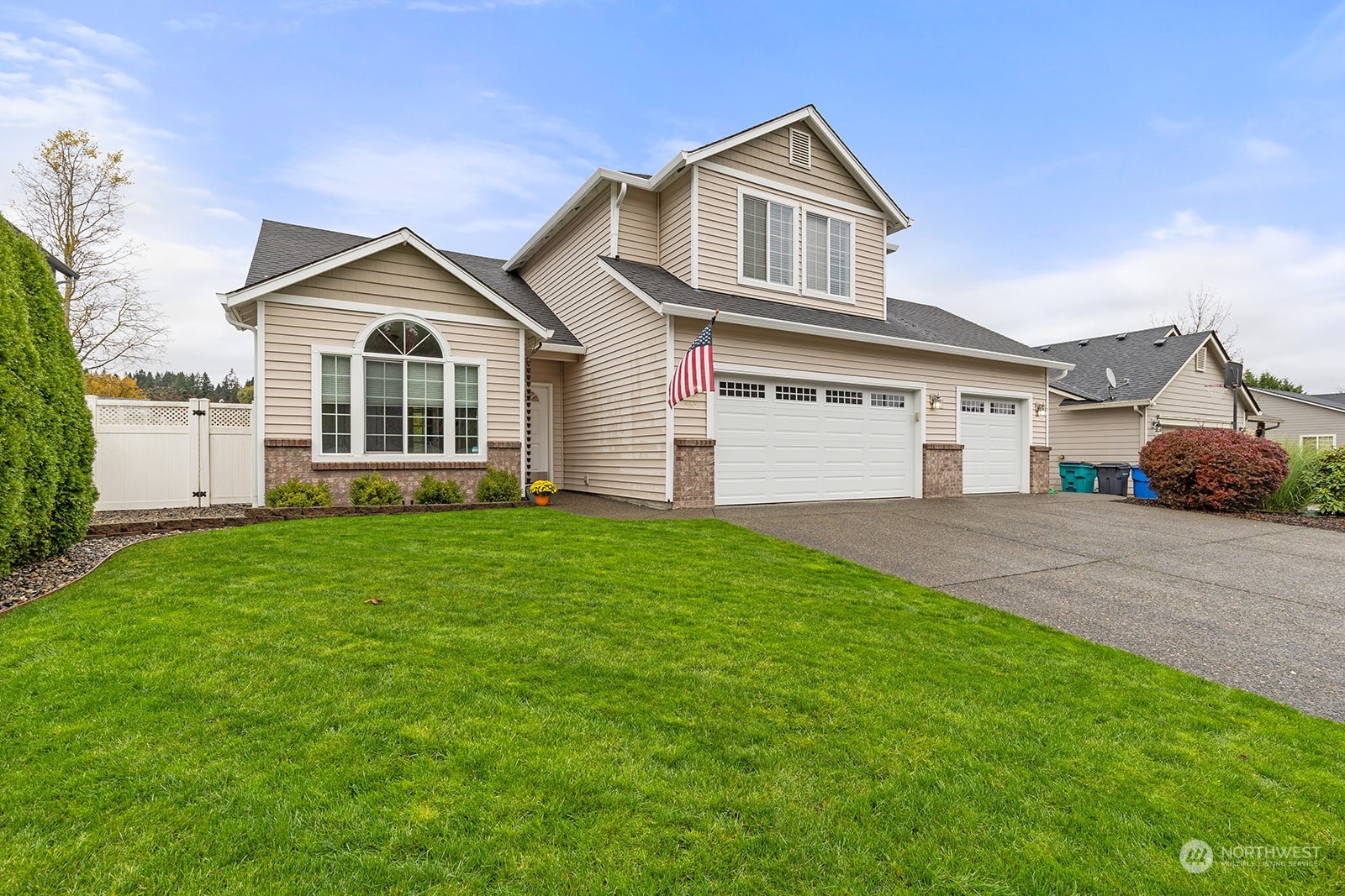 a front view of a house with a yard and trees