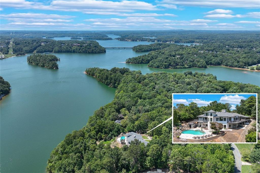 an aerial view of a house with garden space and lake view