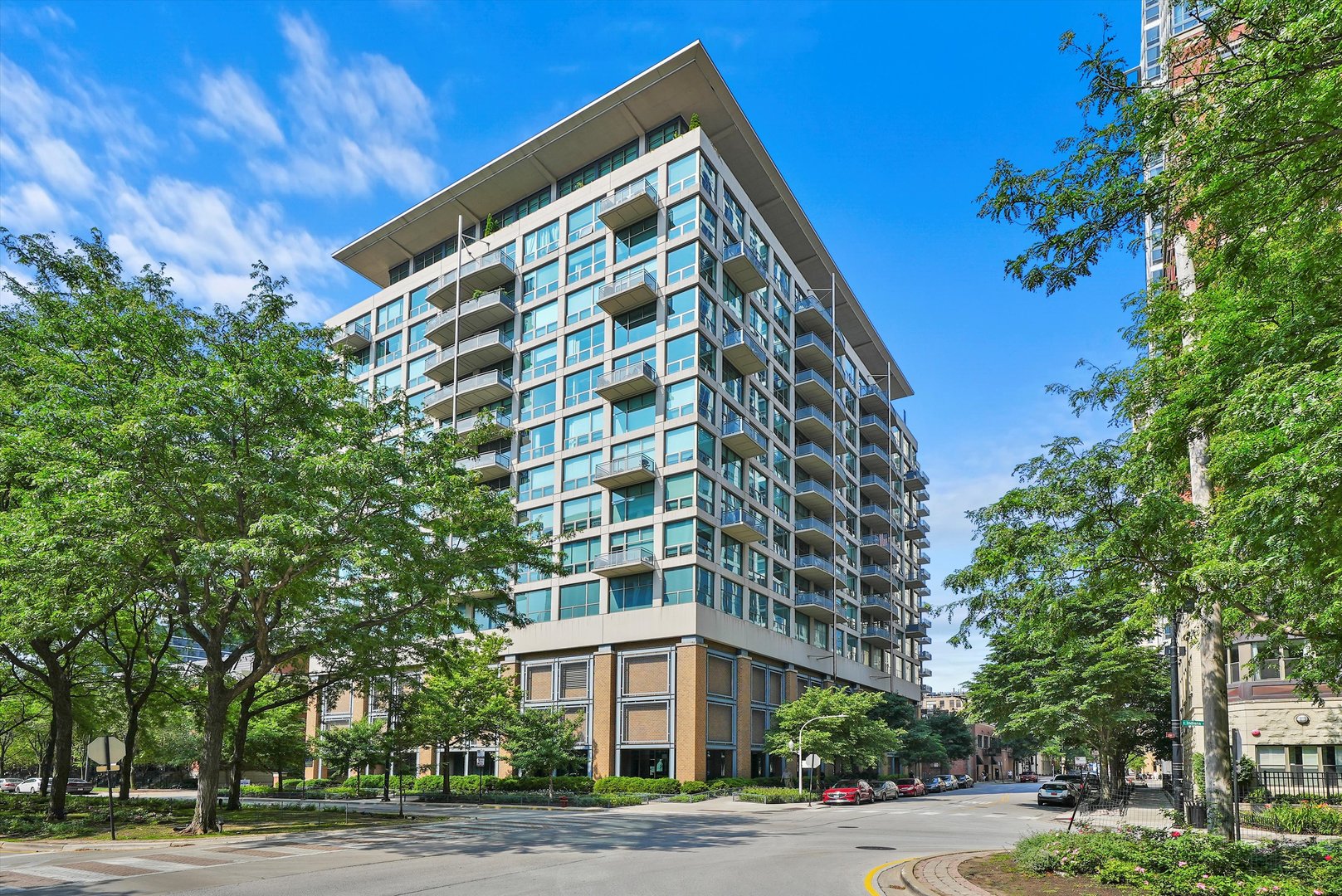 a view of a tall building next to a road