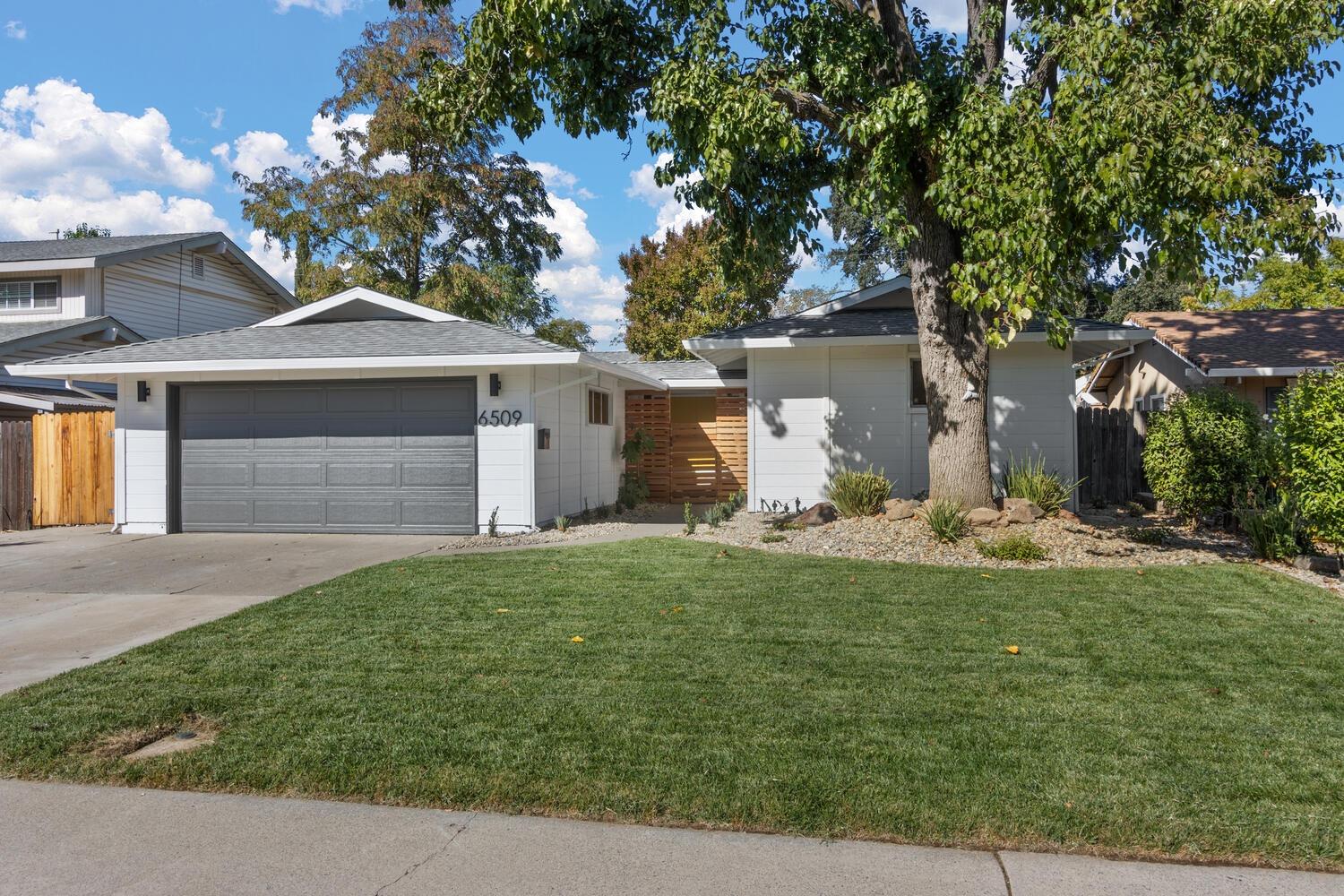 a front view of a house with a yard and garage