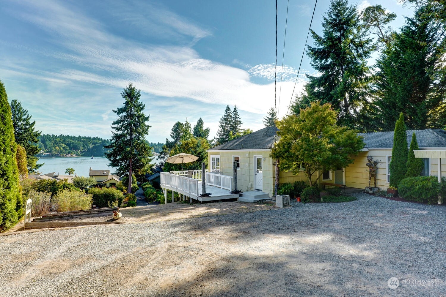 a view of a house with a yard and potted plants