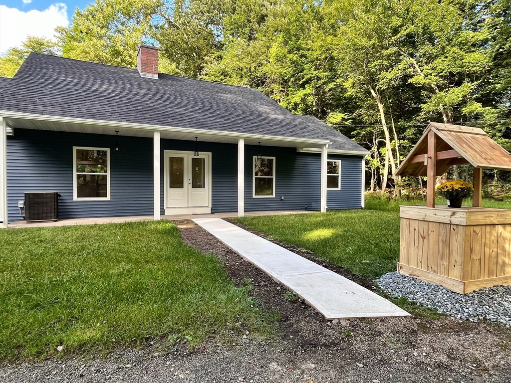 a front view of a house with yard and green space