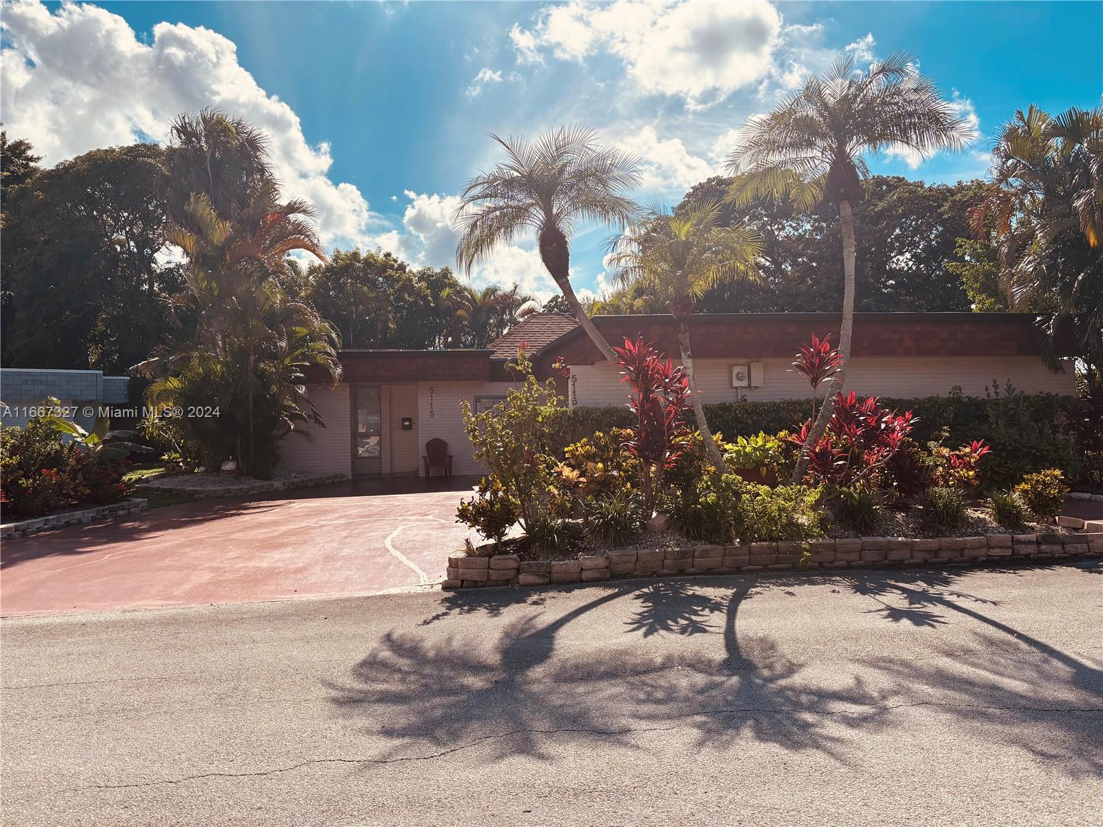 a view of a house with a yard and a street