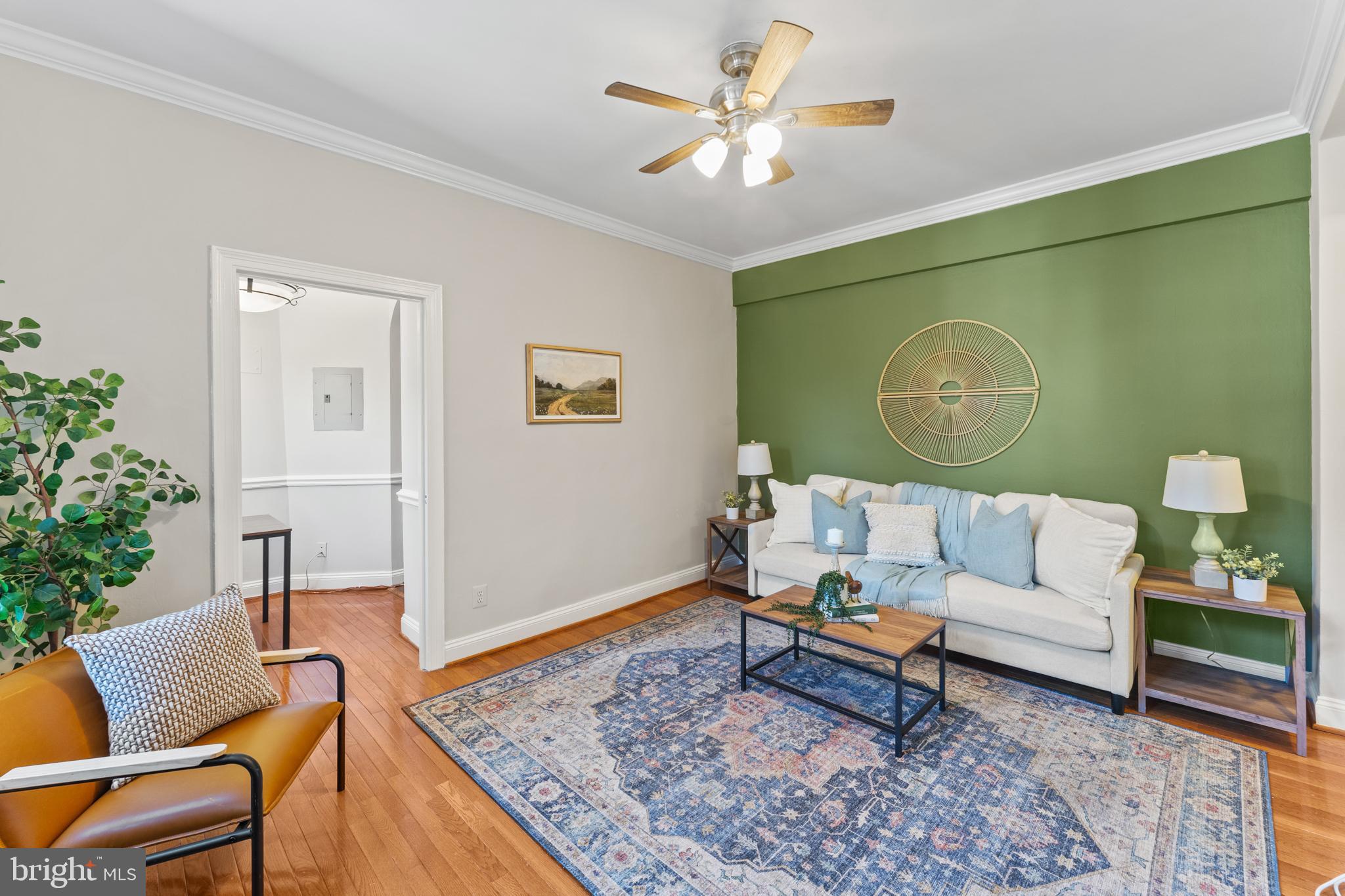 a living room with furniture and wooden floor