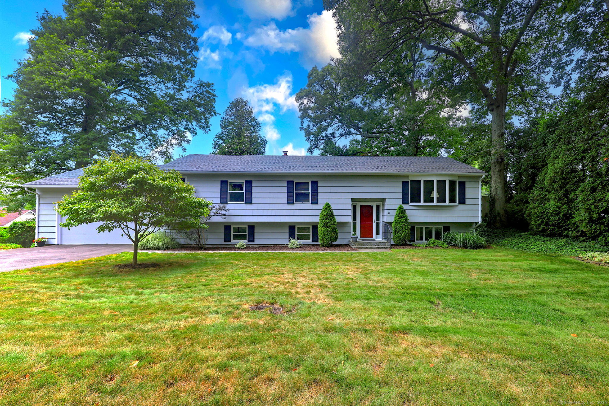 a front view of a house with a garden