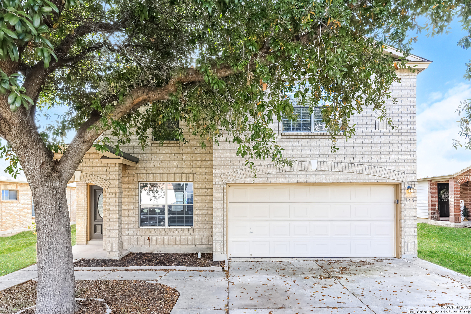 a front view of a house with trees