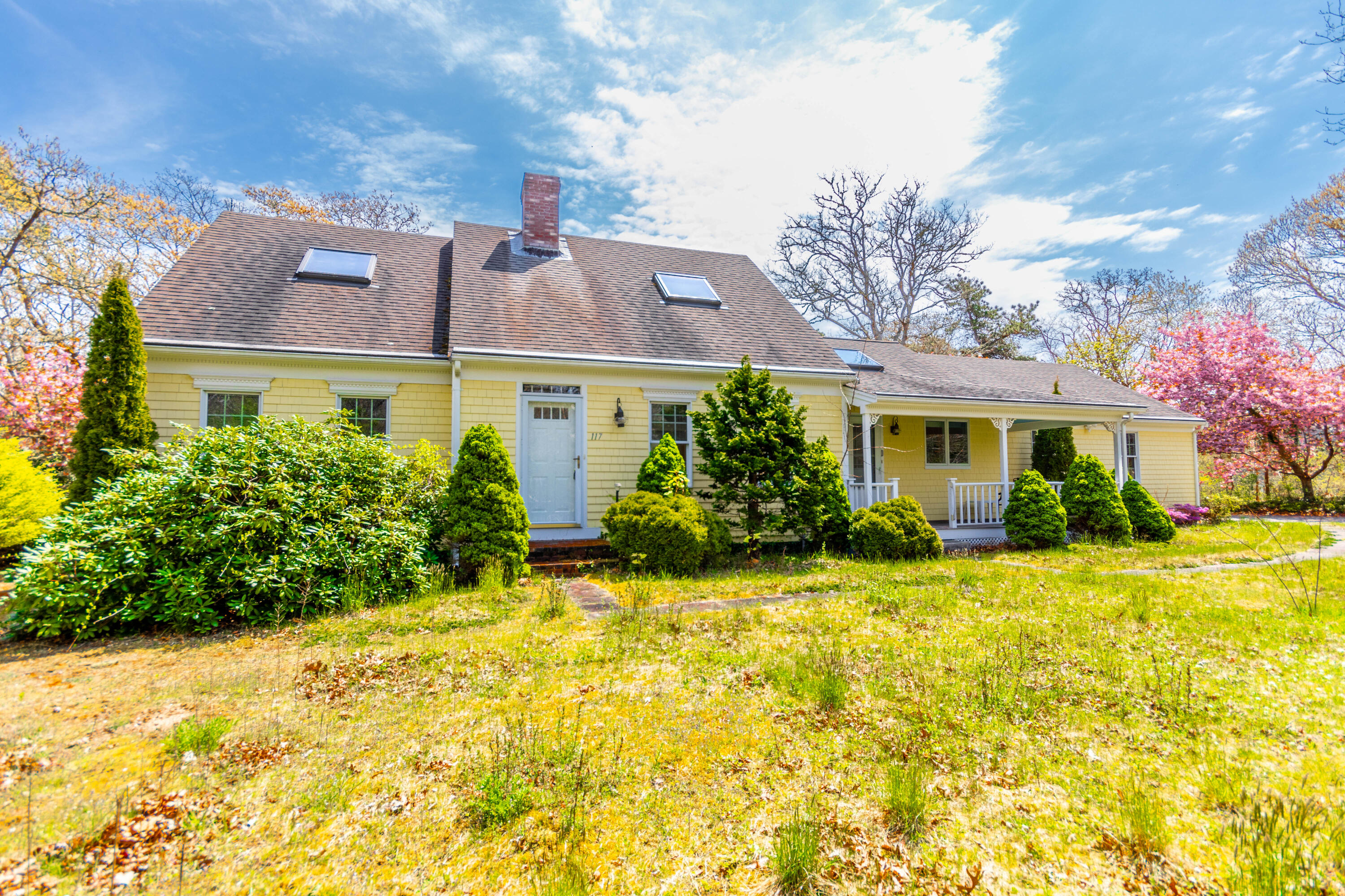 a front view of house with yard and trees around