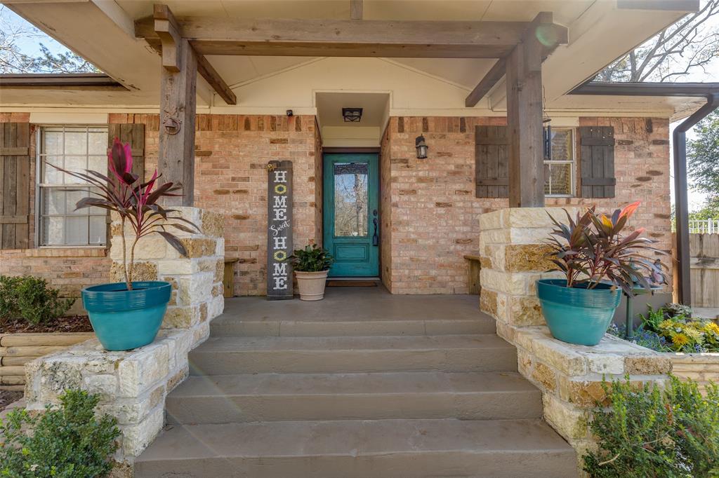 a front view of a house with potted plants