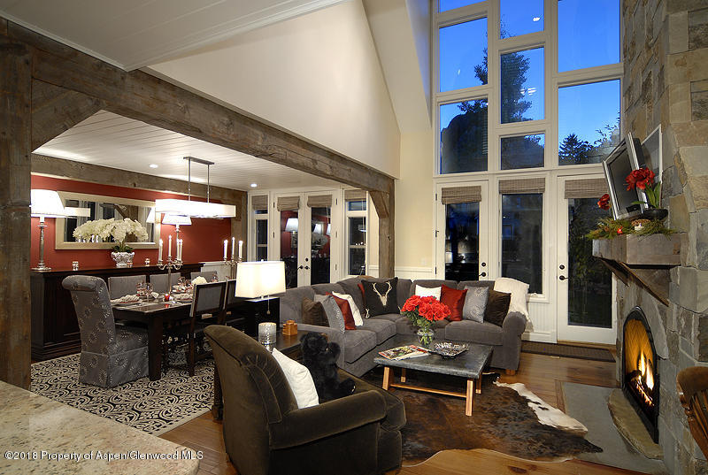 a living room with fireplace furniture and a large window