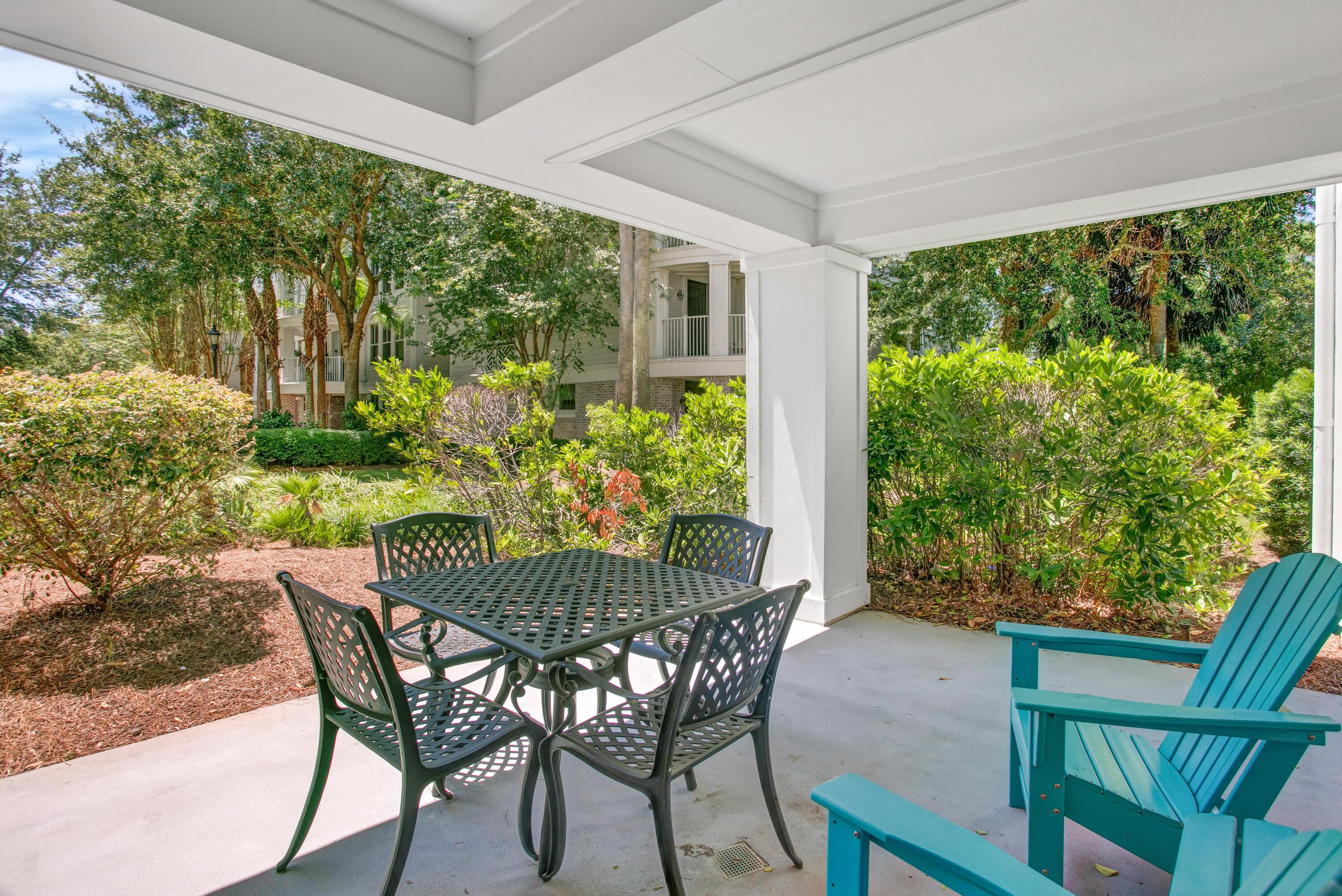 a view of an outdoor dining space with furniture and garden view