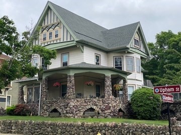 a front view of a house with a garden