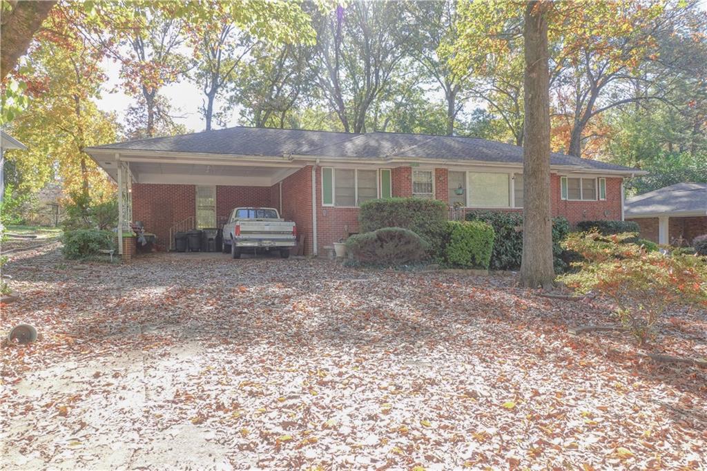 a view of a house with a backyard and a tree