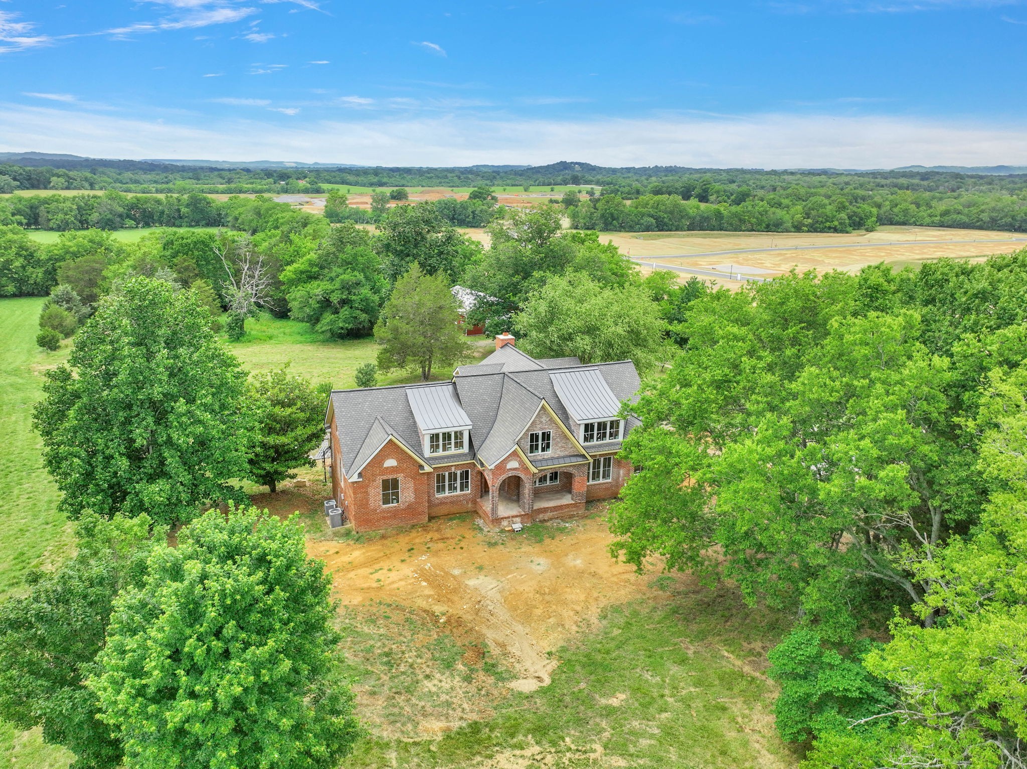 an aerial view of a house with big yard