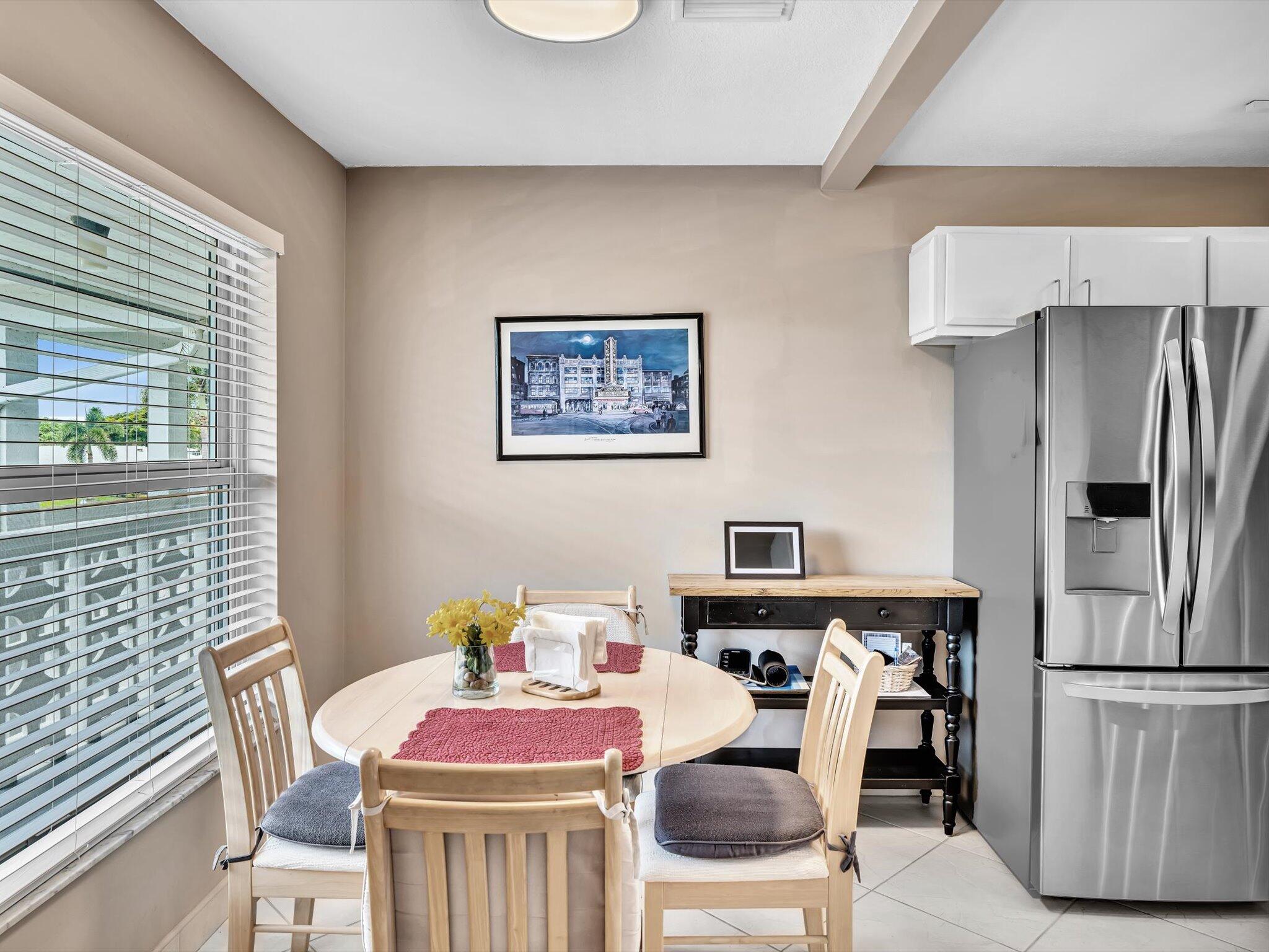 a dining room with furniture and kitchen view