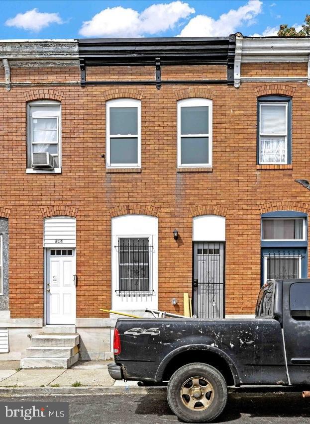 a front view of a house with parking space