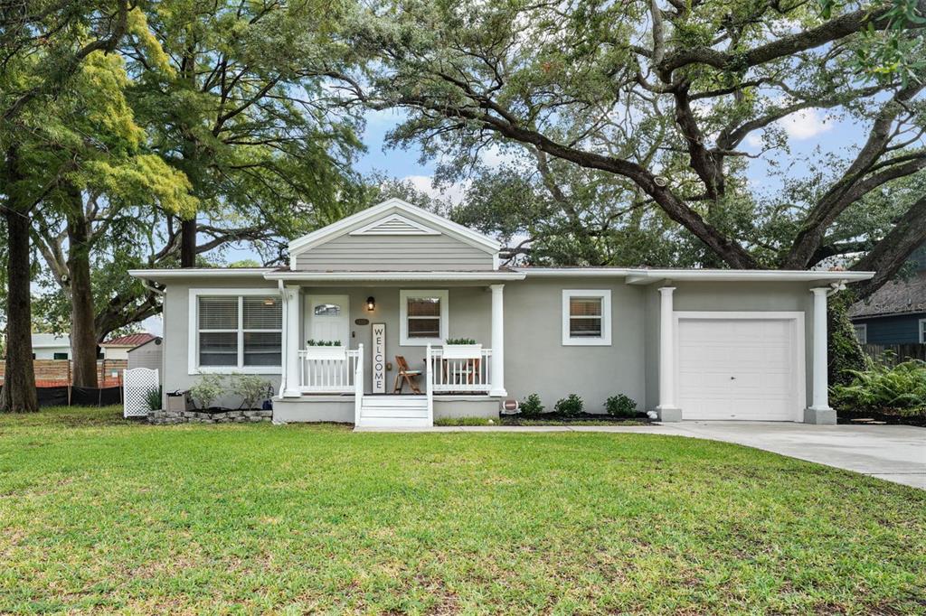 Front Exterior cute front porch. Great parking-garage, driveway and on-street. Oversized 1-car garage (high ceilings for extra storage!)