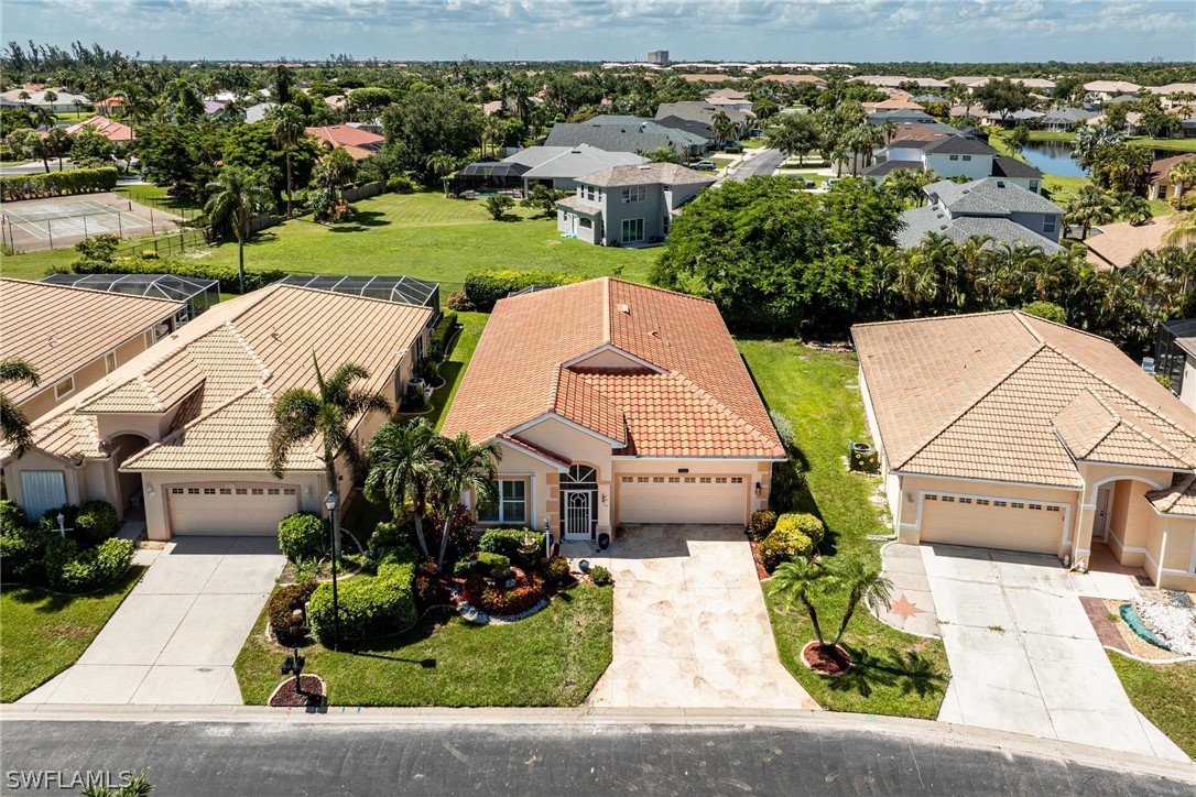 an aerial view of a house with garden space and street view